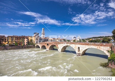 The Ponte Pietra roman arch bridge crossing the Adige River in Verona town, Italy, Europe. The Ponte Pietra roman arch bridge crossing the Adige River in Verona town, Italy, Europe. 122700262