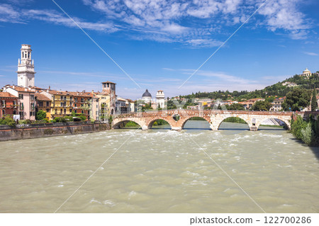 The Ponte Pietra roman arch bridge crossing the Adige River in Verona town, Italy, Europe. 122700286