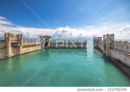The walls of the Scaligero Castle on Lake Garda in historical centre of Sirmione, Italy, Europe. The walls of the Scaligero Castle on Lake Garda in historical centre of Sirmione, Italy, Europe. 122700295