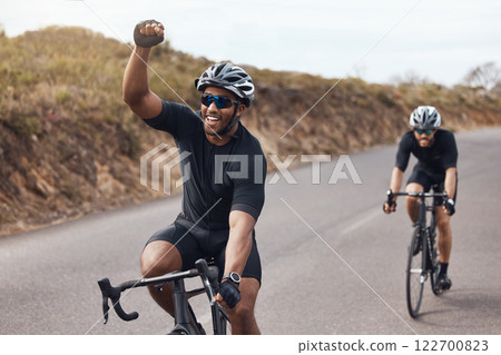 Winner, celebrating and winning cyclist cycling with his friend and racing outdoors in nature. Victory, joy and happy bicycle rider exercising on a bike for his workout routine on the road 122700823