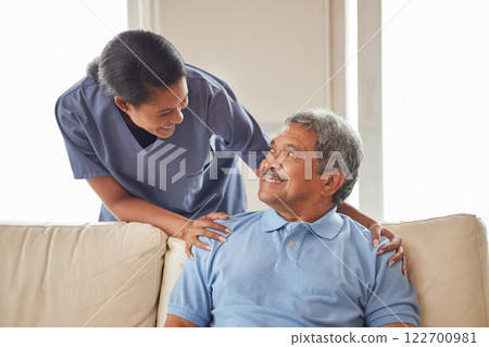 Healthcare, support and nurse working in senior care, bonding with patient showing affection in retirement home. Happy health care worker smiling, caring for mature man in an assisted living facility 122700981