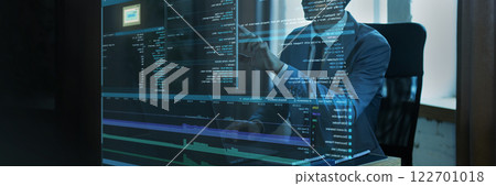 Businessman interacting with virtual code interface. Transparent digital screen displaying fictional programming script 122701018