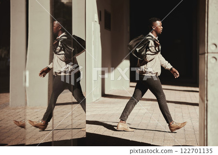 Stylish, travel and a trendy young man walking out of a building or airport in a city. African American man or traveler traveling in an urban town with good style and fashion going to a hotel Stylish, travel and a trendy young man walking out of a building or airport in a city. African American man or traveler traveling in an urban town with good style and fashion going to a hotel 122701135