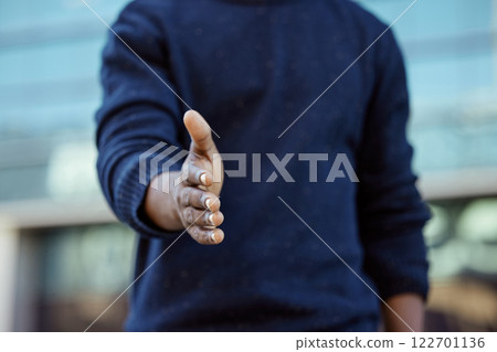 Welcome, trust and support, a man with his hand out for a handshake. A friends offer to shake hands, a thank you, a friendly hello or help. Agreement of a deal or partnership at a business meeting. Welcome, trust and support, a man with his hand out for a handshake. A friends offer to shake hands, a thank you, a friendly hello or help. Agreement of a deal or partnership at a business meeting. 122701136