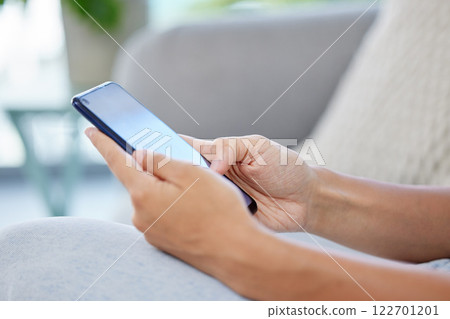 Social media, online shopping and surfing the internet, woman on a phone on a sofa. Communication, conversation or payment online on a sofa. Relax and chat or working in ecommerce with web technology 122701201