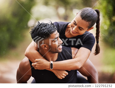 Fun and playful couple playing on a hike in nature, giving piggyback and enjoying a walk in the outdoors together. Happy boyfriend carrying and holding girlfriend, embracing and laughing while hiking Fun and playful couple playing on a hike in nature, giving piggyback and enjoying a walk in the outdoors together. Happy boyfriend carrying and holding girlfriend, embracing and laughing while hiking 122701232