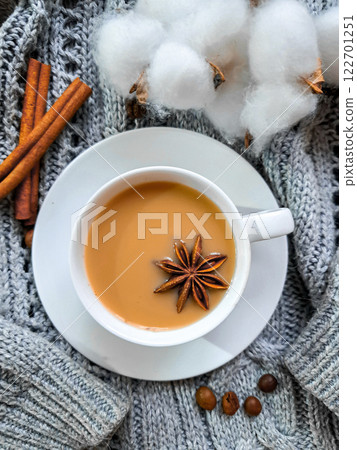 White cup of coffee with cinnamon and anise. Winter mood. The photo radiates warmth and comfort 122701251