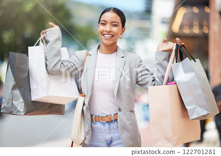 Woman shopping, fashion and retail gift bags for customer buying stylish clothes and spending money on a city spree. Portrait smile, happy and fun lady with cool, trendy and sales presents from store Woman shopping, fashion and retail gift bags for customer buying stylish clothes and spending money on a city spree. Portrait smile, happy and fun lady with cool, trendy and sales presents from store 122701281