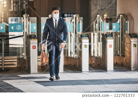 Travel business man during covid arriving in urban city at bus, train or airport terminal. Corporate businessman, employee or worker with suitcase walking in the street to hotel or meeting with mask Travel business man during covid arriving in urban city at bus, train or airport terminal. Corporate businessman, employee or worker with suitcase walking in the street to hotel or meeting with mask 122701333