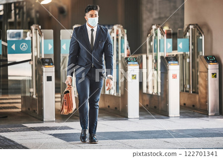 Covid, health and safety on public transport, a businessman walking in a bus or train station in a business suit and face mask. Career, travel and an office worker on his morning journey in the city. Covid, health and safety on public transport, a businessman walking in a bus or train station in a business suit and face mask. Career, travel and an office worker on his morning journey in the city. 122701341