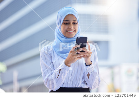 Islam, islamic or business woman on her phone in hijab texting in the city with mockup. Diversity, muslim and arabic international employee on mobile working in town or global corporate company. 122701449