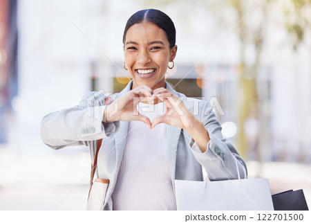 Shopping woman with love and heart sign or hand in an urban city street with retail bags. Professional fashion business female, customer and designer with self care or emoji hands, portrait and smile Shopping woman with love and heart sign or hand in an urban city street with retail bags. Professional fashion business female, customer and designer with self care or emoji hands, portrait and smile 122701500