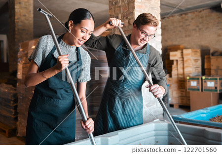 Cellar workers, making wine and mixing open tank with stirring, pressing and crushing tool for alcohol production. Happy staff and merchants in factory distillery, winery and manufacturing warehouse Cellar workers, making wine and mixing open tank with stirring, pressing and crushing tool for alcohol production. Happy staff and merchants in factory distillery, winery and manufacturing warehouse 122701560