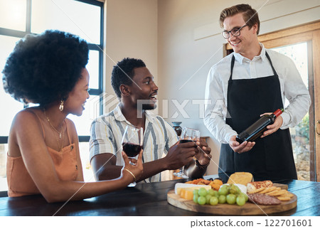 Hospitality industry, restaurant service and waiter showing wine to couple on romantic date, talking and looking happy. Lovers enjoying conversation with sommelier and celebrating their relationship 122701601