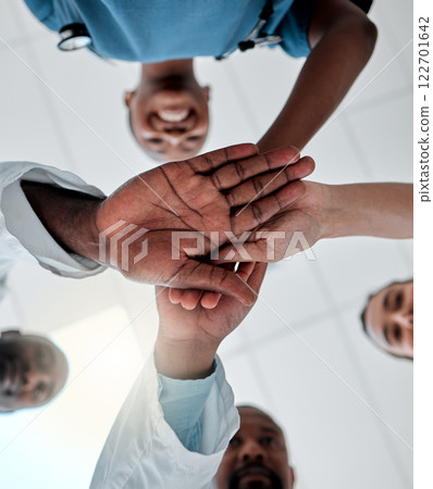 Goal of a group of doctors with their hands together in support, unity and trust together ready for surgery in hospital. Below view of medical team or healthcare professionals winning and celebrating 122701642