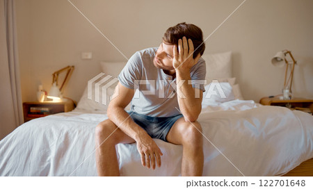 Depression, mental health and sad man in stress feeling bad, upset and depressed alone in his home, house or hotel suite. Wake up, morning and frustrated, unhappy male in bedroom tired with anxiety Depression, mental health and sad man in stress feeling bad, upset and depressed alone in his home, house or hotel suite. Wake up, morning and frustrated, unhappy male in bedroom tired with anxiety 122701648
