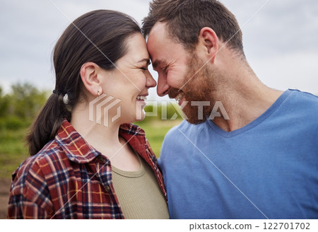 Happy mature couple bonding, laughing and having a romantic, intimate moment outdoors together. Smiling husband and wife showing affection, embracing. Soulmate feeling free, loving their relationship 122701702