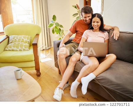 Relax, love and laptop with a young couple surfing the internet with wireless technology on the sofa in the living room at home. Weekend, bonding and learning together in a house over the weekend 122701711