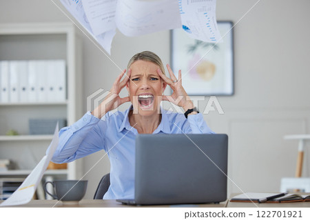 Angry, stress and woman screaming at her office desk in frustration and fear at work issues. Serious panic, rage or headache from news about audit, tax or bankruptcy while at corporate job. 122701921