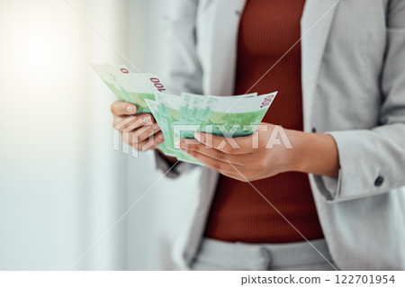 Hands counting money to make payment, budget or savings with cash during inflation. Closeup of lady making a financial stock investment or checking her finance salary increase after a promotion. Hands counting money to make payment, budget or savings with cash during inflation. Closeup of lady making a financial stock investment or checking her finance salary increase after a promotion. 122701954
