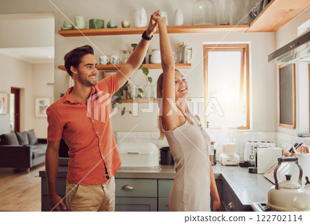Happy, dancing and loving couple bonding and having fun while spending time together at home. Energetic, fun and active couple sharing a dance and romantic moment while enjoying their anniversary 122702114