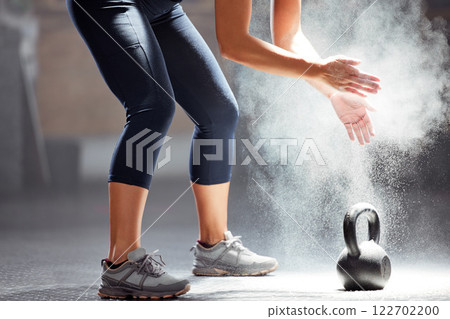 Fit, dust, kettle bell of female in fitness clapping hands of chalk in the gym. Healthy, wellness and athletic woman preparing for training exercise or workout, motivation and sports. 122702200