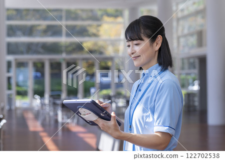 Image of facility staff operating a tablet Image of facility staff operating a tablet 122702538
