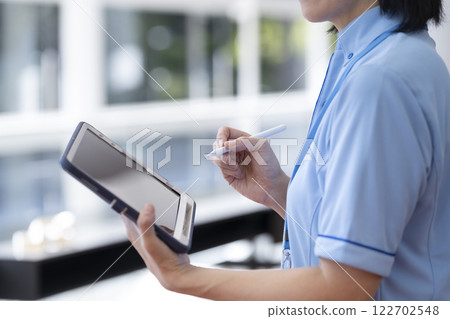 Facility staff holding a tablet 122702548