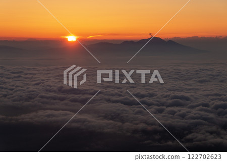 Mount Asama and sea of clouds with rising smoke from the morning sun at Mount Daitenjo in the Northern Alps 122702623