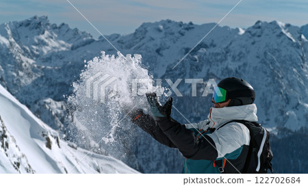 Skier throwing snow in the Italian Dolomites during sunny day , Alpine scenery 122702684