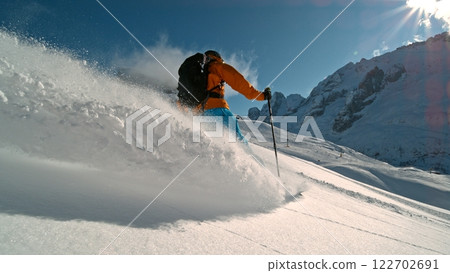 Skier riding in the scenic Alps mountains in fresh powder snow , beautiful sunny day Skier riding in the scenic Alps mountains in fresh powder snow , beautiful sunny day 122702691