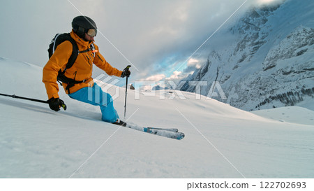 Skier riding in the scenic Alps mountains in fresh powder snow , beautiful sunny day 122702693