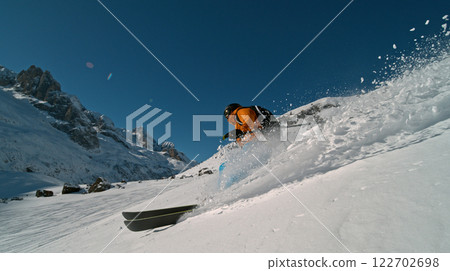 Skier riding in the scenic Alps mountains in fresh powder snow , beautiful sunny day 122702698