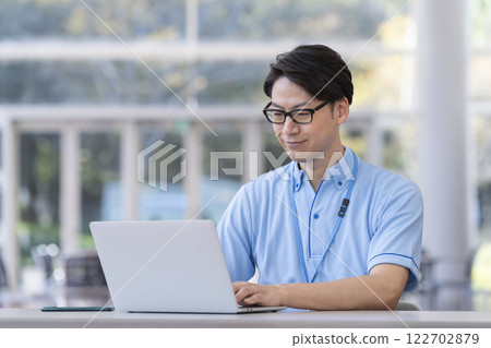 Image of a facility staff member working on a laptop Image of a facility staff member working on a laptop 122702879