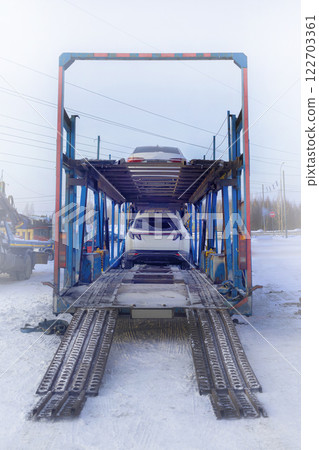 Car carrier. Loading cars on a car carrier. Transportation of cars anywhere in the country Car carrier. Loading cars on a car carrier. Transportation of cars anywhere in the country 122703361