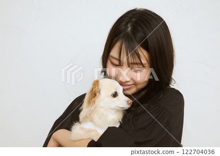 Woman holding a pet Woman holding a pet 122704036