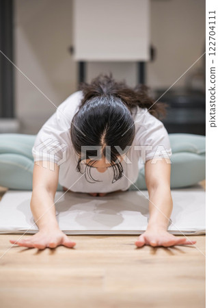 Smiling young woman stretching 122704111