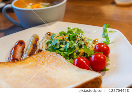 Healthy breakfast plate with toast, sausage and vegetable soup 122704458