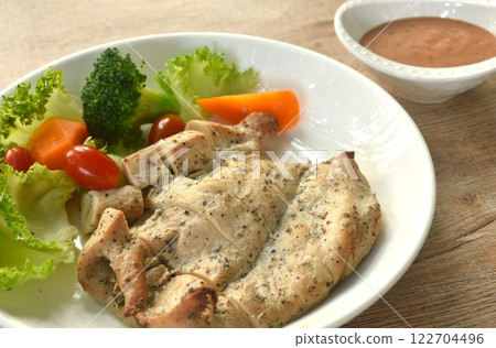 grilled slice chicken breast steak black pepper with barbecue sauce and baking vegetable salad on plate  122704496