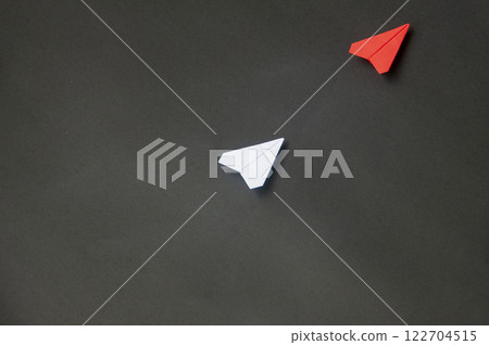 Top view of red paper airplane origami leading white airplane on blue dark background. Leadership skills concept 122704515