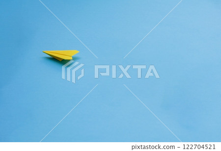 Yellow paper airplane on blue background Yellow paper airplane on blue background 122704521
