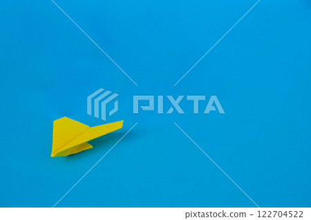 Side view of yellow paper airplane on blue background with customizable space for text. Business and Leadership skills concept Side view of yellow paper airplane on blue background with customizable space for text. Business and Leadership skills concept 122704522