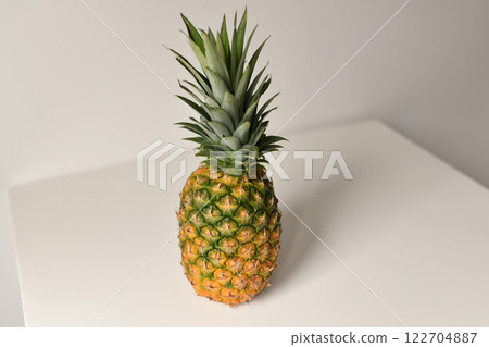 Pineapple on white table and background. Isolated. Summer concept. Flat lay, top view. Pineapple on white table and background. Isolated. Summer concept. Flat lay, top view. 122704887