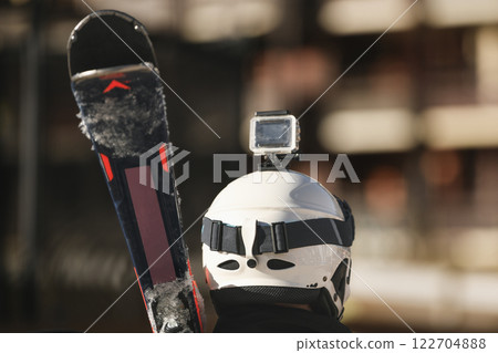 Blogger skier with skis, protective helmet and video camera on helmet in the mountains Blogger skier with skis, protective helmet and video camera on helmet in the mountains 122704888