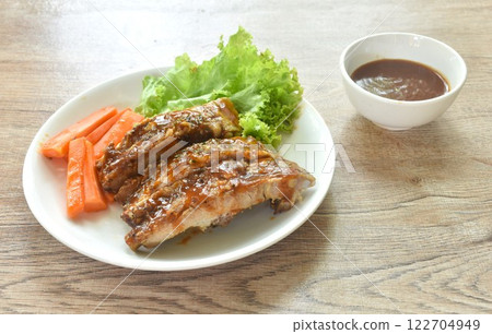 grilled pork rib with carrot and lettuce on plate dipping barbecue sauce cup grilled pork rib with carrot and lettuce on plate dipping barbecue sauce cup 122704949