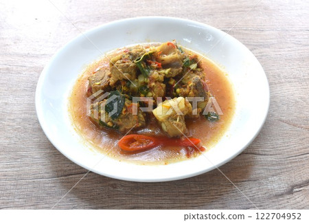 spicy fried pork soft bone with curry and basil on plate  122704952