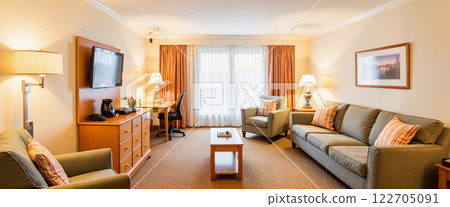 Cozy and inviting hotel suite with modern amenities and large windows 122705091