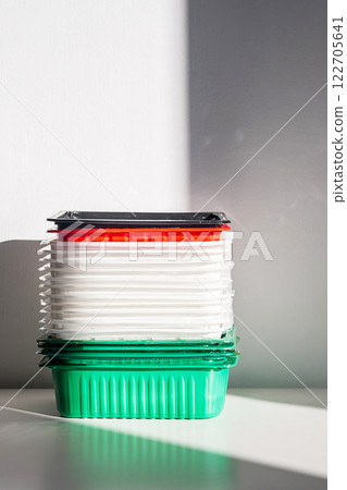 Pile of disposable plastic food containers ready for sorting and recycling. 122705641
