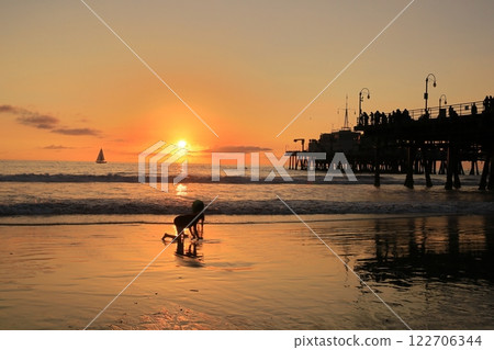 Children having fun watching the sunset on the beach at Santa Monica Pier Children having fun watching the sunset on the beach at Santa Monica Pier 122706344