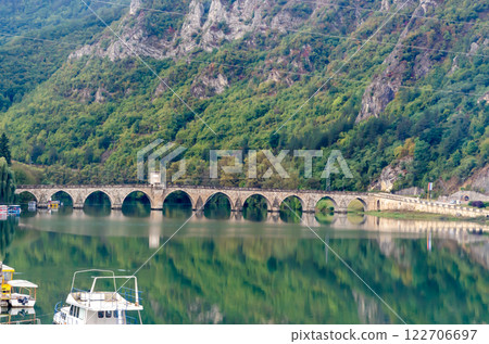 Bridge on the river Drina with reflection of mountains in the water Bridge on the river Drina with reflection of mountains in the water 122706697